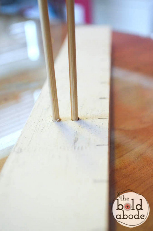 DIY ribbon making tool using a board and dowels - gift wrapping guide