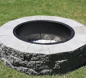 Concrete landscaping stones fire pit with a metal fire pit ring