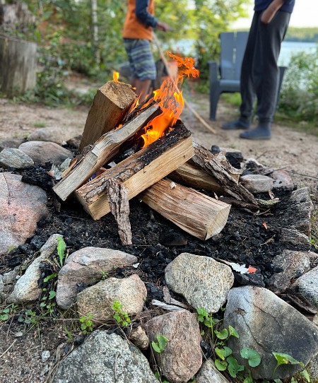 country-cottage-exterior-design-bonfire-with-lakeside-view