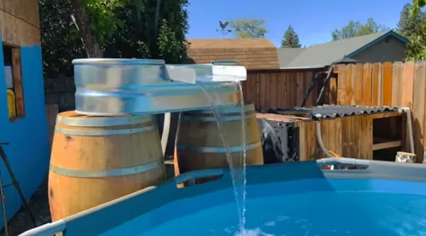 diywaterfallusingbarrelsforabovegroundpool