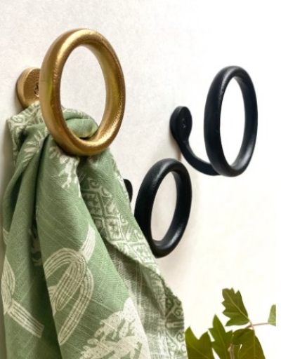 Use coat hooks to display bathroom towels like this Hand forged Metal round towel holder.