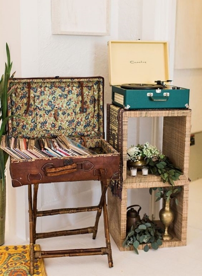 a-stand-with-a-turn-table-and-a-vintage-suitcase-placed-on-legs-for-storing-viny