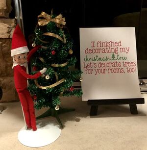 Elf-decorating-Christmas-tree
