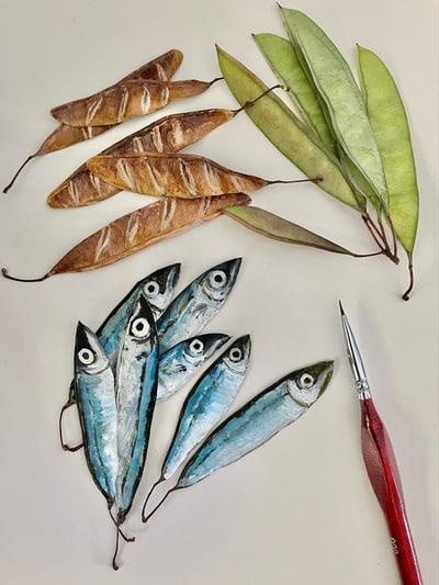 hand-painting-dried-pea-pods-sardines