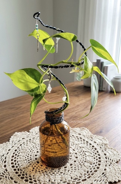water-plant-display-idea-amber-bottle-and-wire-structure