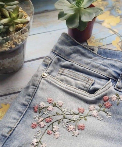 Hand-embroidered-floral-vines-below-the-front-pocket