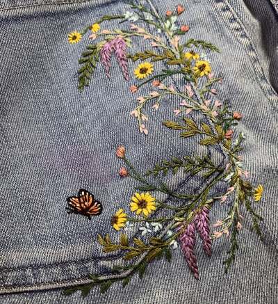 Pocket details on a pair of mended jeans